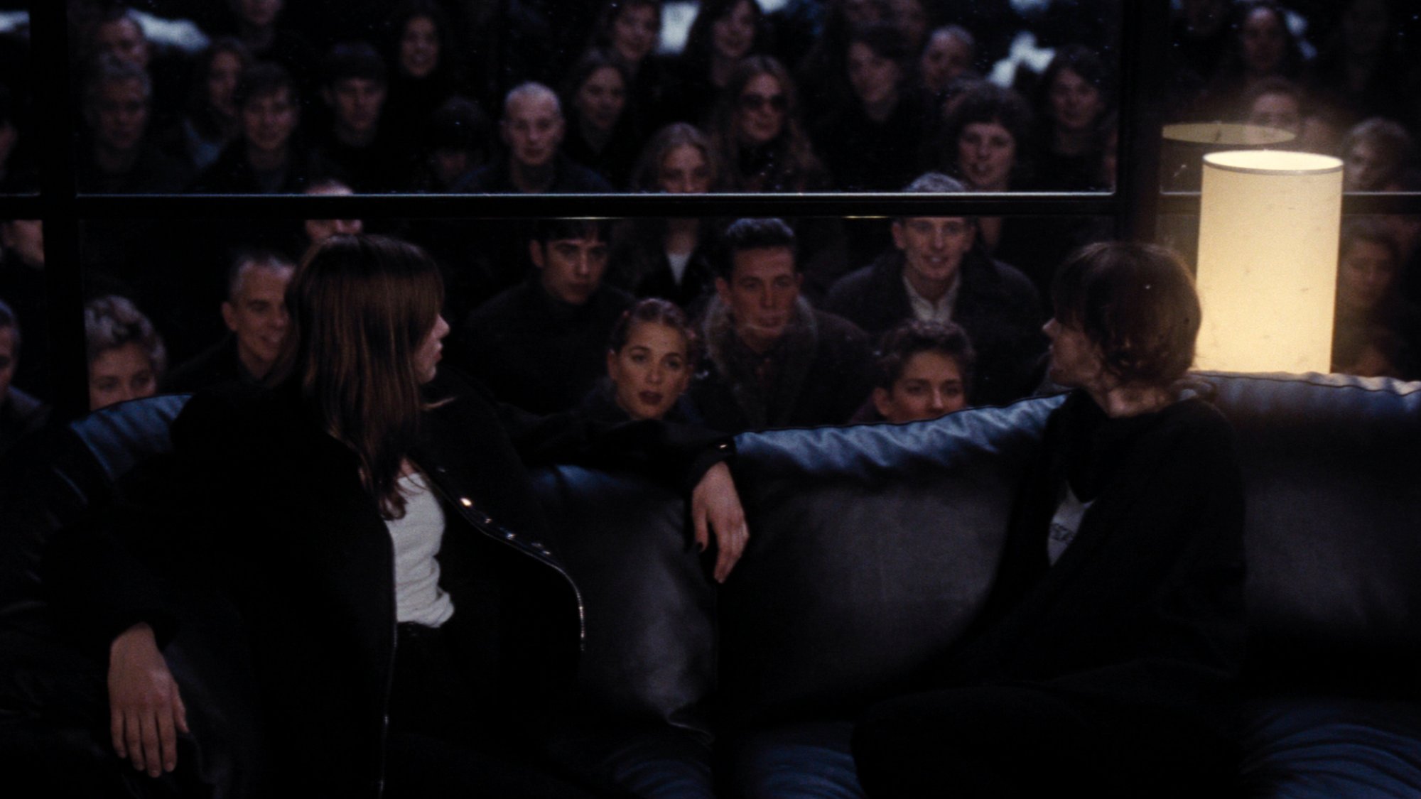 The gaze — an audience seen through frosted glass, watching and being watched