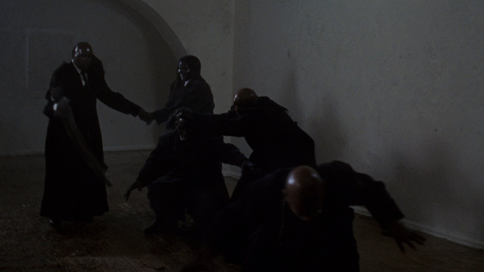 The witnesses — dark silhouettes emerging from fog, observing in silence