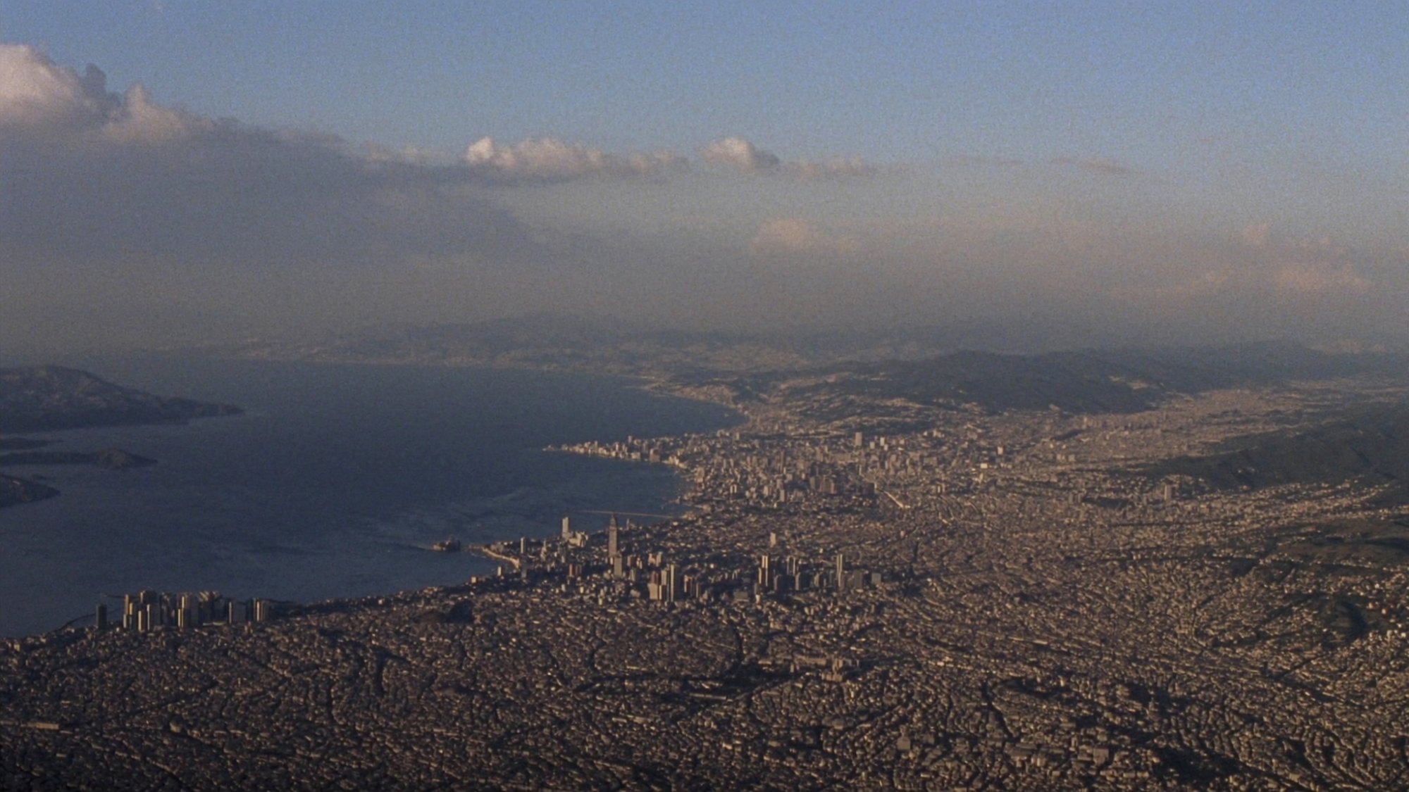 Naples from above — the city sprawling across the bay, body becoming geography